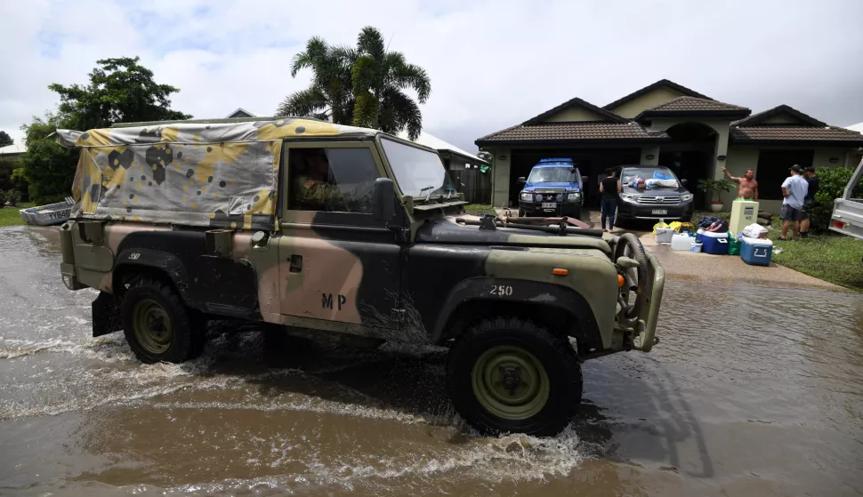 epa07344426 An army vehicle drives past houses affected by floods in the suburb of Hermit Park in Townsville, Queensland, Austrlia, 05 February 2019. Residents have begun cleaning up after days of torrential rain and unprecedented water releases from the city's swollen dam, sending torrents of water down the Ross River and into the city, swamping roads, yards and homes. EPA/DAN PELED AUSTRALIA AND NEW ZEALAND OUT
