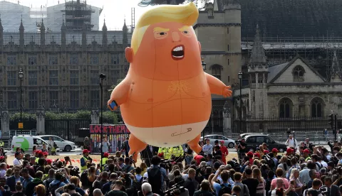 epa06885212 The 'Donald Trump Baby Blimp' balloon flies over Parliament Square during a protest in London, Britain, 13 July 2018. The inflatable dubbed 'Trump Baby' tied to a spot in Parliament Square is to kick off a day of protests against US President Donald J. Trump's visit. Trump is on a working visit to Britain. EPA/ANDY RAIN