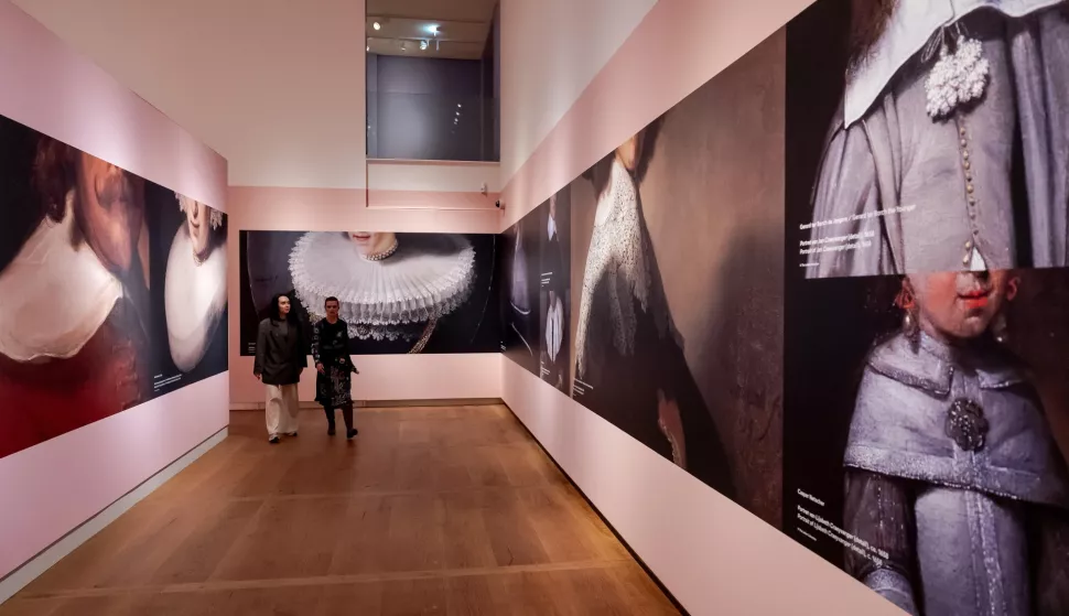 epa12017870 Visitors look on enlarged sections of paintings on display at the 'From Rembrandt to Vermeer, Masterpieces from The Leiden Collection' exhibition at the H'ART Museum in Amsterdam, Netherlands, 08 April 2025. The exhibition, celebrating 750th birthday of the city of Amsterdam, showcases works from the Leiden Collection and runs from 09 APril to 24 August 2025. EPA/ROBIN VAN LONKHUIJSEN