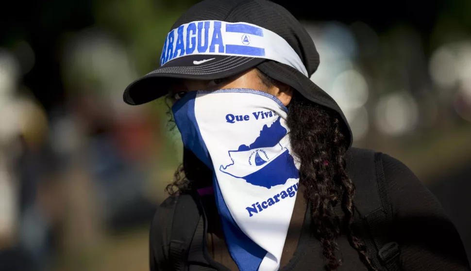 epa06820013 A young girl with her face covered participates in a sit-in at an event held to commemorate the start of the anti-government protests in Nicaragua, which have been sustained for two months, and have resulted in the deaths of at least 180 people, in Managua, Nicaragua, 18 June 2018. Dozens of people returned to peacefully protest in the same place where two months ago a sit-in was held to reject reforms to Social Security in Nicaragua, and became the catalyst for the anti-government protests and political violence in the Central American country. EPA/JORGE TORRES