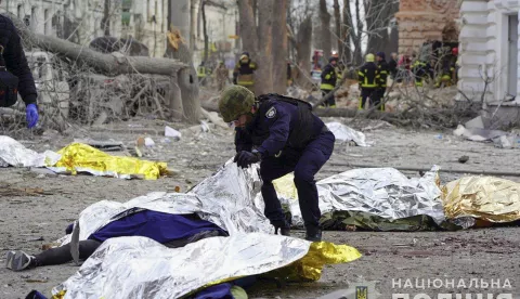 epa12029026 GRAPHIC CONTENT - A handout photo made available by the National Police of Ukraine shows a police officer inspecting the bodies of the victims at the site of a rocket strike in downtown Sumy, Ukraine, 13 April 2025, amid the ongoing Russian invasion. At least 31 people were killed, including two children, and 84 people were injured, including 10 children, after a Russian rocket hit downtown Sumy in the morning, according to a report by the State Emergency Service. EPA/NATIONAL POLICE OF UKRAINE HANDOUT -- ATTENTION EDITORS: GRAPHIC CONTENT -- HANDOUT EDITORIAL USE ONLY/NO SALES