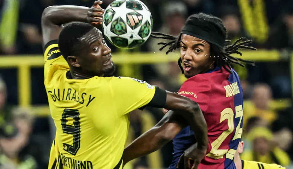 epa12033809 Serhou Guirassy (L) of Dortmund in action against Jules Kounde of Barcelona during the UEFA Champions League quarter-finals, 2nd leg soccer match between Borussia Dortmund and FC Barcelona, in Dortmund, Germany, 15 April 2025. EPA/FRIEDEMANN VOGEL