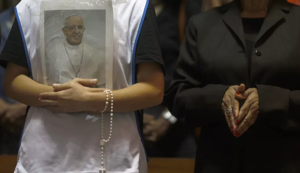 epa12045370 A person holds a portrait of Pope Francis during a mass at the Metropolitan Cathedral in Rio de Janeiro, Brazil, 21 April 2025. Pope Francis died on 21 April 2025 at the age of 88, according to the Holy See. Born Jorge Mario Bergoglio in Buenos Aires, Argentina, on 17 December 1936, he was appointed leader of the Catholic Church on 13 March 2013, succeeding Pontiff Emeritus Benedict XVI. EPA/ANTONIO LACERDA