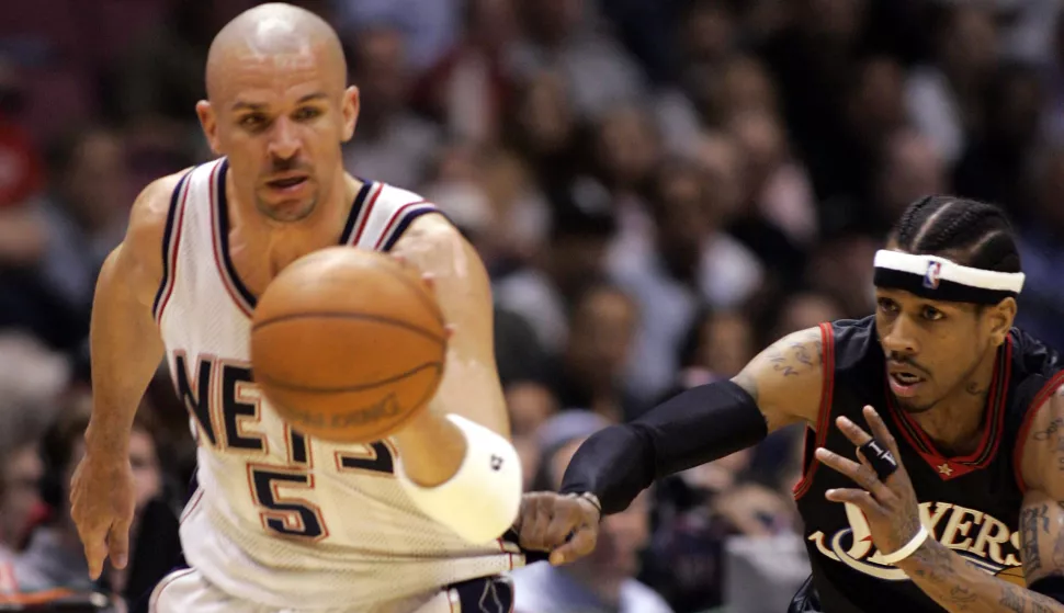 Philadelphia 76ers guard Allen Iverson (R) pulls at the jersey of New Jersey Nets guard Jason Kidd (5) after he stole the ball and broke away in the first period of their NBA game in East Rutherford, New Jersey, April 17, 2005. REUTERS/Ray Stubblebine