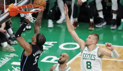 epa12043620 Orlando Magic forward Paolo Banchero (L) drives to the basket past Boston Celtics guard Derrick White (C) and Boston Celtics center Kristaps Porzingis (R) during the third quarter of the Eastern Conference First Round playoff game one between the Boston Celtics and the Orlando Magic in Boston, Massachusetts, USA, 20 April 2025. EPA/CJ GUNTHER SHUTTERSTOCK OUT