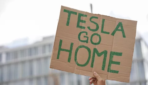 epa12011745 An activist holds a placard during a 'Tesla Takedown' protest in front of a Tesla store in Berlin, Germany, 05 April 2025. The Tesla Takedown movement, which encourages people to sell their Tesla stocks and vehicles, called for protests in Germany on 05 April in front of Tesla stores and showrooms as part of a global day of action against Tesla CEO Elon Musk. EPA/ELLEN KALLSCHEUER