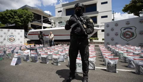 epa12057264 An agent from the National Drug Control Directorate guards confiscated cocaine packages, in Santo Domingo, Dominican Republic, 26 April 2025. Dominican anti-narcotics authorities reported on 26 April the seizure of 993 packets of cocaine on a vessel docked at a pier in the Cap Cana resort complex, in the province of La Altagracia (east). EPA/Orlando Barria