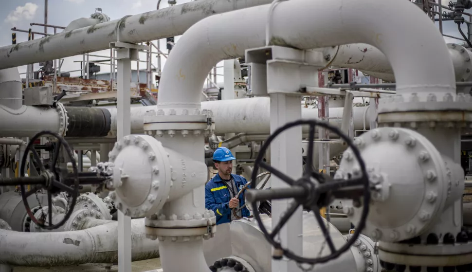 epa10122970 An employee checks control wheel on pipelines at the Central oil tank farm operated by Mero CR near Nelahozeves, Czech Republic, 15 August 2022. Mero CR owns and operates the Czech part of the Druzhba pipeline and the IKL pipeline, is the sole transporter of crude oil to the Czech Republic, and also provides storage for the Czech emergency strategic oil reserves. Both pipelines enter the Central oil tank farm near Nelahozeves, where the company has built a total of 17 oil tanks with a total storage capacity of 1 675 000 m3. In June 2022, the European Union approved a sixth package of sanctions over Russia's invasion of Ukraine, which includes a ban on most Russian oil imports from the turn of the year. Oil transport via the Druzhba pipeline supplying the Czech Republic, Slovakia and Hungary will be temporarily excluded from the embargo. EPA/MARTIN DIVISEK