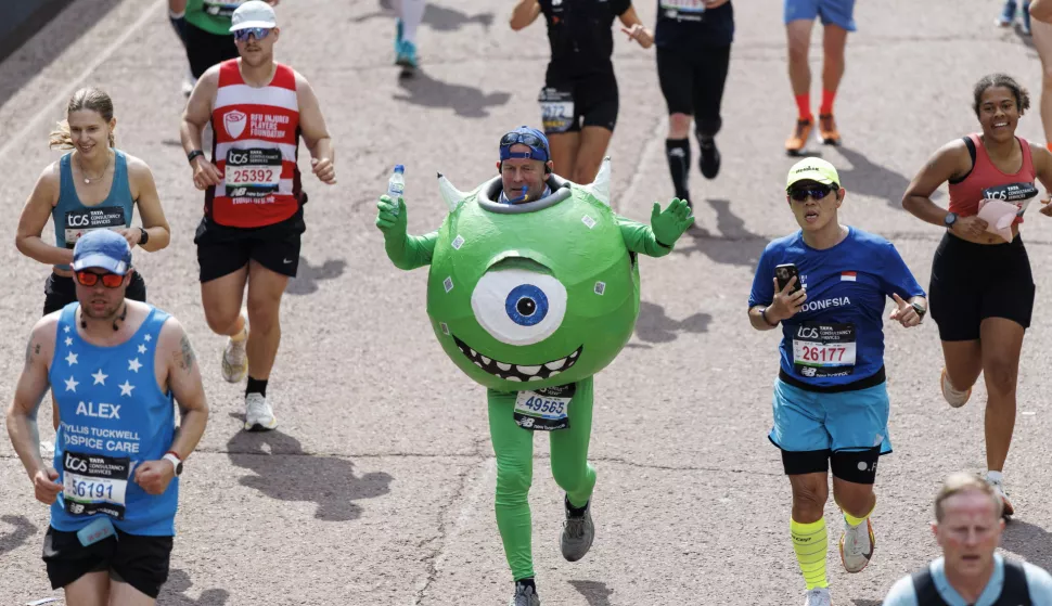 epa12058492 A person wearing a costume of Mike Wazowski from 'Monsters, Inc' film crosses the finish line of London Marathon in London, Britain, 27 April 2025. Taking place since 1981, the London Marathon is one of the most popular marathons in the world, with a record-breaking total of more than 56,000 people are expected to take part in the 2025 race. EPA/TOLGA AKMEN