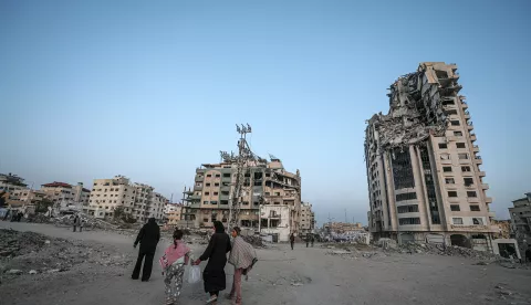 epa12069815 Internally displaced Palestinians walk between destroyed buildings in Gaza City, 02 May 2025. According to the UN, at least 1.9 million people (or nine in ten people) across the Gaza Strip are internally displaced, including people who have been repeatedly displaced. Since October 2023, only about 11 percent of the Gaza Strip has not been placed under Israeli-issued evacuation orders, the UN aid coordination office OCHA said. EPA/MOHAMMED SABER