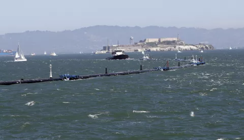 epa07007085 The Ocean Cleanup system is towed past Alcatraz Island, a San Francisco landmark, in San Francisco, California USA, 08 September 2018. The Ocean Cleanup launched the world's first cleanup system headed to the Great Pacific Garbage Patch which is the largest accumulation of plastic in the world. EPA/MONICA DAVEY