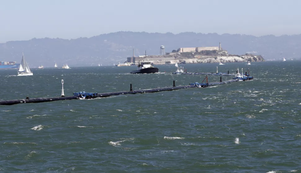 epa07007085 The Ocean Cleanup system is towed past Alcatraz Island, a San Francisco landmark, in San Francisco, California USA, 08 September 2018. The Ocean Cleanup launched the world's first cleanup system headed to the Great Pacific Garbage Patch which is the largest accumulation of plastic in the world. EPA/MONICA DAVEY