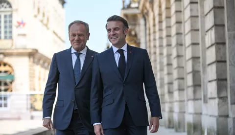 epa12086753 French President Emmanuel Macron (R) and Polish Prime Minister Donald Tusk (L) talk on Stanislas Square in Nancy, France, 09 May 2025. French President Macron and Polish Prime Minister Tusk met in Nancy as part of a summit to sign the French-Polish Strategic Pact, a treaty of friendship and enhanced cooperation between France and Poland. EPA/MARCIN OBARA POLAND OUT