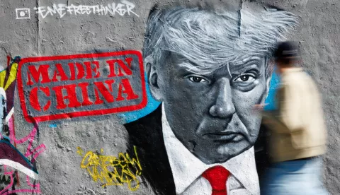epaselect epa12060350 A passer-by walks in front of a graffito of Berlin-based artist Eme Freethinker that shows US President Donald J. Trump next to the writing 'Made in China' at the Mauerpark in Berlin, Germany, 28 April 2025. The United States of America and China are in a fight about tariff policies. EPA/CLEMENS BILAN