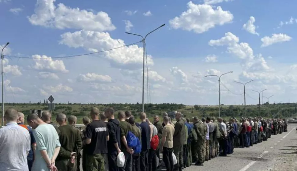 epa10042215 A handout picture made available by the press service of the Defense Intelligence of the Ministry of Defense of Ukraine, shows Ukrainian prisoners of war who were released as part of a prisoner swap with Russia, walking towards the Ukrainian side at an undisclosed location, Ukraine, 29 June 2022. The 144 Ukrainian soldiers were released from Russian captivity, 95 of them were part of the Azovstal (Mariupol) fighters. According to a statement by the Ukrainian Presidential Office on 06 June quoting President Zelensky, there may be more than 2,500 prisoners from the Azovstal plant being held captive by Russian forces. EPA/Defense Intelligence Ministry of Defense of Ukraine HANDOUT EDITORIAL USE ONLY NO SALES HANDOUT EDITORIAL USE ONLY/NO SALES