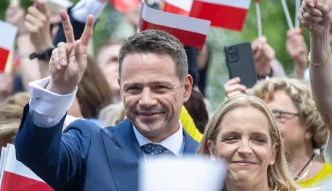 epa12130794 Mayor of Warsaw and Civic Coalition (KO) Presidential candidate Rafal Trzaskowski (L) with his wife Malgorzata Trzaskowska (R), meet with local residents in Ciechocinek, Poland, 24 May 2025. Rafal Trzaskowski will compete against Karol Nawrocki in the Poland's presidential elections run-off on 01 June 2025, after neither candidate secured more than 50 percent of the vote in the first round on 18 May. EPA/TYTUS ZMIJEWSKI POLAND OUT