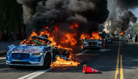 WayMo Taxis are set ablaze during protests against ICE raids being conducted throughout the city and county of LA. Demonstrators gathered on June 08, 2025, for a third day of street battles that led to unrest. (Photo by Jacob Lee Green/Sipa USA) Photo: Jacob Lee Green/SIPA USA