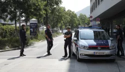 epa12168093 Police officers stand guard outside of the Dreierschutzengasse high school following a shooting in Graz, Austria, 10 June 2025. At least nine people were killed in the incident, including the shooter, authorities confirmed. EPA/ANTONIO BAT