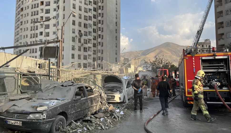 epaselect epa12172720 Fire fighters work outside a building that was hit by Israeli air strikes north of Tehran, Iran, 13 June 2025. Israel confirms it has launched strikes on Iran's 'nuclear program' as blasts are heard across the country. The strikes are part of Operation Rising Lion, Israel's Prime Minister Benjamin Netanyahu said, adding Iran was a threat to "Israel's very survival". EPA/ABEDIN TAHERKENAREH
