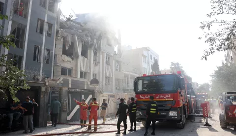epa12172799 Fire fighters, rescue workers and security personnel work around a building that was hit by Israeli air strikes in central Tehran, Iran, 13 June 2025. Israel confirms it has launched strikes on Iran's 'nuclear program' as blasts are heard across the country. The strikes are part of Operation Rising Lion, Israel's Prime Minister Benjamin Netanyahu said, adding Iran was a threat to "Israel's very survival". EPA/ABEDIN TAHERKENAREH