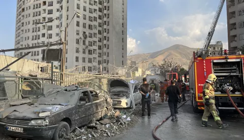 epaselect epa12172720 Fire fighters work outside a building that was hit by Israeli air strikes north of Tehran, Iran, 13 June 2025. Israel confirms it has launched strikes on Iran's 'nuclear program' as blasts are heard across the country. The strikes are part of Operation Rising Lion, Israel's Prime Minister Benjamin Netanyahu said, adding Iran was a threat to "Israel's very survival". EPA/ABEDIN TAHERKENAREH
