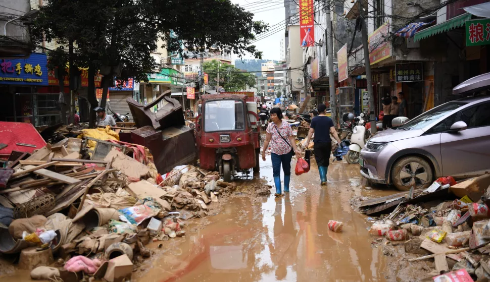 epa12186560 Residents walk on a flood-hit road in Huaiji County, Guangdong Province, China, 19 June 2025 (issued 20 June 2025). The National Development and Reform Commission said on 18 June that it has allocated 60 million yuan (about 8.36 million U.S. dollars) from the central budget to support flood relief efforts in Guangdong Province. About 300,000 people were affected and 70,000 relocated in Zhaoqing-administered Huaiji following days of heavy rain, according to local officials. EPA/XINHUA/Deng Hua CHINA OUT/UK AND IRELAND OUT/  MANDATORY CREDIT EDITORIAL USE ONLY EDITORIAL USE ONLY
