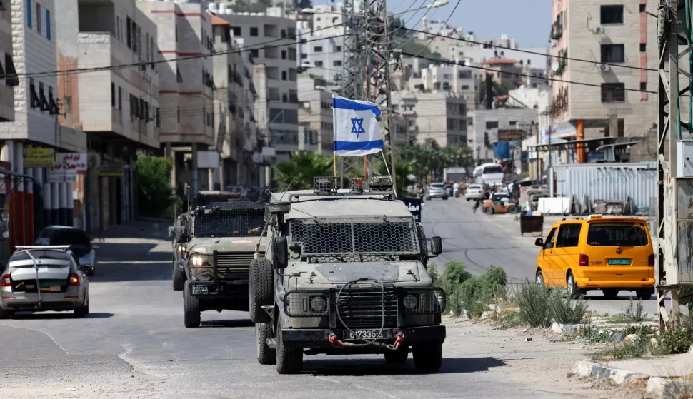 epa12183457 Israeli army vehicles move in the streets during a military operation in the Balata refugee camp, near the West Bank city of Nablus, 18 June 2025. According to the Palestinian Health Ministry, at least 20 Palestinians were wounded during the operation. EPA/ALAA BADARNEH