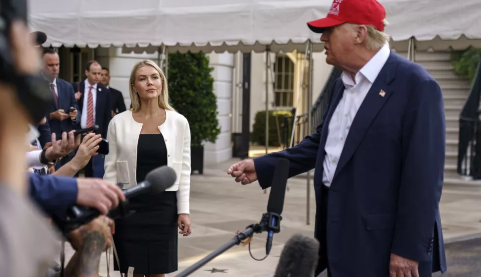 epa12208233 White House Press Secretary Karoline Leavitt (L) listens as US President Donald Trump speaks to the media as he leaves the White House in Washington, DC, USA, 01 July 2025. President Trump is due to visit a new immigration detention facility in the Everglades, Florida. EPA/WILL OLIVER/POOL
