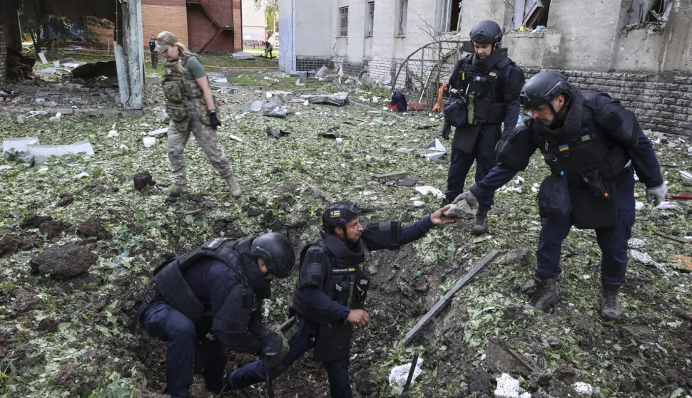 epa12221778 Ukrainian experts work at the site of a drone strike on a residential building in Kharkiv, northeastern Ukraine, 07 July 2025, amid the Russian invasion. According to the State Emergency Service (SES), at least 29 people were injured, including three children, following a Russian attack by shock drones on Kharkiv and its suburbs. EPA/SERGEY KOZLOV