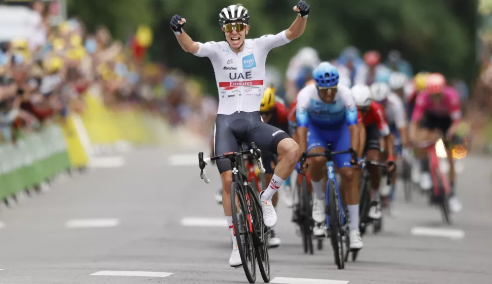 epa10057238 Slovenian rider Tadej Pogacar of UAE Team Emirates celebrates as he crosses the finish line to win the 6th stage of the Tour de France 2022 over 219.9km from Binche to Longwy, France, 07 July 2022. EPA/YOAN VALAT