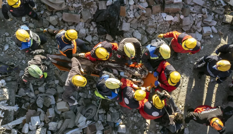 epa10454893 A photo taken with a drone shows rescuers carry a survivor, who was rescued from a collapsed building after 60 hours after an earthquake in Hatay, Turkey, 08 February 2023. More than 11,000 people have died and thousands more are injured after two major earthquakes struck southern Turkey and northern Syria on 06 February. Authorities fear the death toll will keep climbing as rescuers look for survivors across the region. EPA/ERDEM SAHIN
