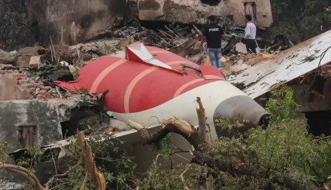 epa12172804 Officials inspects site of an airplane crash near Sardar Vallabhbhai Patel International Airport in Ahmedabad, Gujarat, western India, 13 June 2025. Air India flight AI171, bound for London carrying 242 passengers and crew members on board a Boeing 787-8 aircraft, crashed minutes after take-off in the Meghaninagar area of Ahmedabad. EPA/RAJAT GUPTA