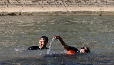epa11483073 Paris Mayor Anne Hidalgo and President of the Paris 2024 Olympics and Paralympics Organising Committee Tony Estanguet (L) swim in the Seine to demonstrate that the river is clean enough to host the outdoor swimming events at Paris 2024 Olympic Games, in Paris, France, 17 July 2024. Despite an investment of 1.4 billion euros (.5 billion) to prevent sewage leaks into the waterway, the Seine has been causing suspense in the run-up to the opening of the Paris Games on 26 July, after repeatedly failing water quality tests. According to the Paris city hall on 12 July, the Seine has been clean enough for swimming for most of the past 12 days. EPA/JOEL SAGET/POOL MAXPPP OUT