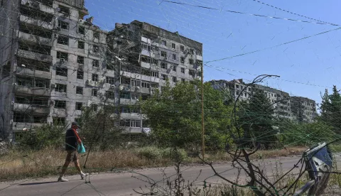 epa12239951 A handout photo made available by the press service of the 65th Separate Mechanised Brigade of Ukrainian Armed Forces shows a local man walking on a street protected by the anti-drone nets of various types amid the ongoing Russian invasion in the city of Orikhiv, Zaporizhzhia region, Ukraine, 15 July 2025. Russian troops entered Ukrainian territory on 24 February 2022, starting a conflict that has provoked destruction and a humanitarian crisis. EPA/Press service of the 65th Mechanized Brigade/HANDOUT HANDOUT EDITORIAL USE ONLY/NO SALES