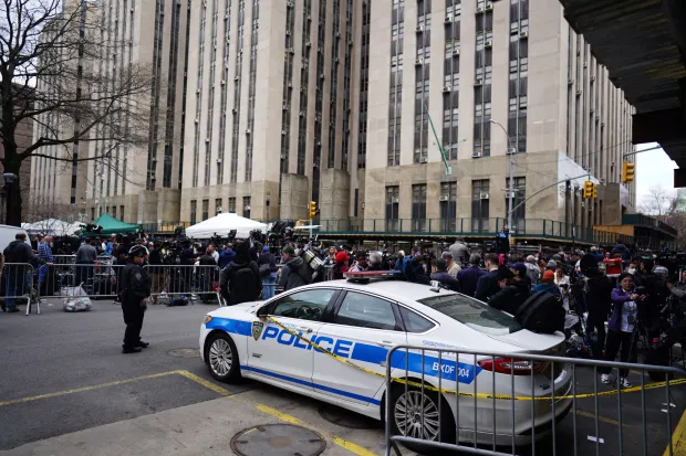 epa10558810 Demonstrators outside New York Criminal Court as former US President Donald J. Trump is arraigned in New York, New York, USA, 04 April 2023. A Manhattan grand jury voted to indict former President Donald J. Trump last week. EPA/WILL OLIVER
