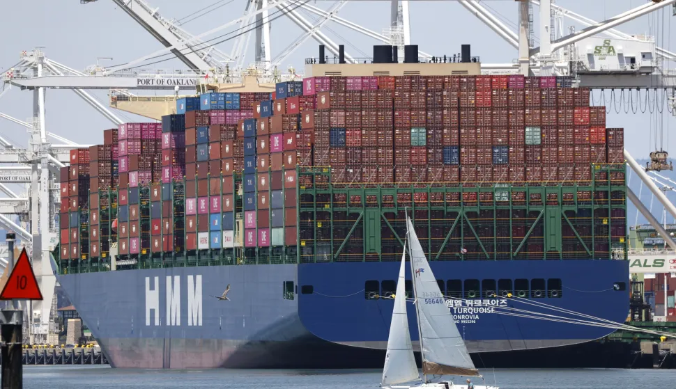 epaselect epa12238224 A sailboat sails past a container ship at the Port of Oakland in Oakland, California, USA, 14 July 2025. Recent tariff increases and trade policies, particularly those related to China, have significantly affected the port's operations and container volume. Shipping lines have been canceling voyages and skipping ports (known as 'blank sailings') in response to the uncertainty and reduced demand caused by tariffs, leading to a decline in container traffic at the Port of Oakland. Last week, US President Trump sent a letter to European Union leaders stating that he would impose a 30 percent tariff on goods imported from the EU beginning 01 August. Trump also threatened to impose 25 percent tariffs on Japan and South Korea, 30 percent on Mexico, and 35 percent on Canada. EPA/JOHN G. MABANGLO
