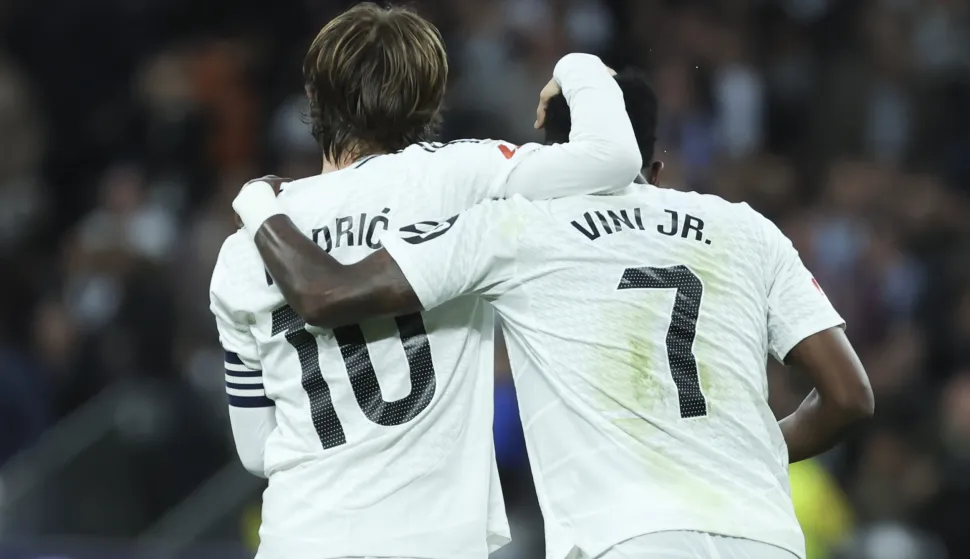 epa11918876 Real Madrid's Vinicius Junior (R) celebrates with his teammate Luka Modric after scoring the 2-0 goal during the Spanish LaLiga soccer match between Real Madrid and Girona FC, in Madrid, Spain, 23 February 2025. EPA/KIKO HUESCA