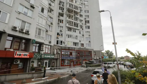 epa12267779 Local people look at a residential building hit in a drone strike in Kyiv, Ukraine, 28 July 2025, amid the Russian invasion. At least eight people were injured, including one child, in Kyiv after Russian forces launched an overnight large-scale combined attack. EPA/SERGEY DOLZHENKO