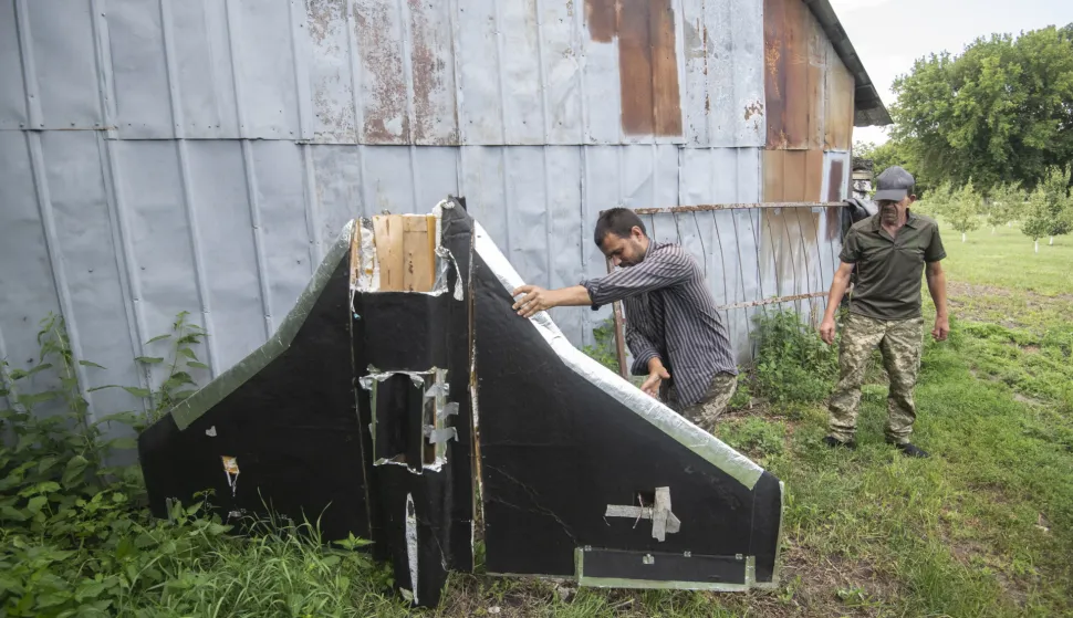 epaselect epa12282145 Ukrainian farmers show a Russian drone which was shot down above their field in the Kyiv region, Ukraine, 03 August 2025, amid the ongoing Russian invasion. EPA/MAXYM MARUSENKO