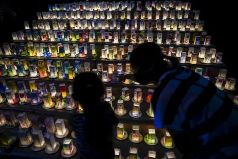 epa08591531 A young girl with her mother looks at hundreds of lanterns with messages of peace at the Peace Park in Nagasaki, southern Japan, 08 August 2020. Nagasaki is preparing to mark the 75th anniversary of the 1945 atomic bombing on 09 August as related events are either canceled or scaled down this year to avoid the spreading of the coronavirus disease (COVID-19) pandemic. In 1945 the United States dropped two nuclear bombs over the cities of Hiroshima and Nagasaki on 06 and 09 August respectively, killing more than 200,000 people. EPA/DAI KUROKAWA
