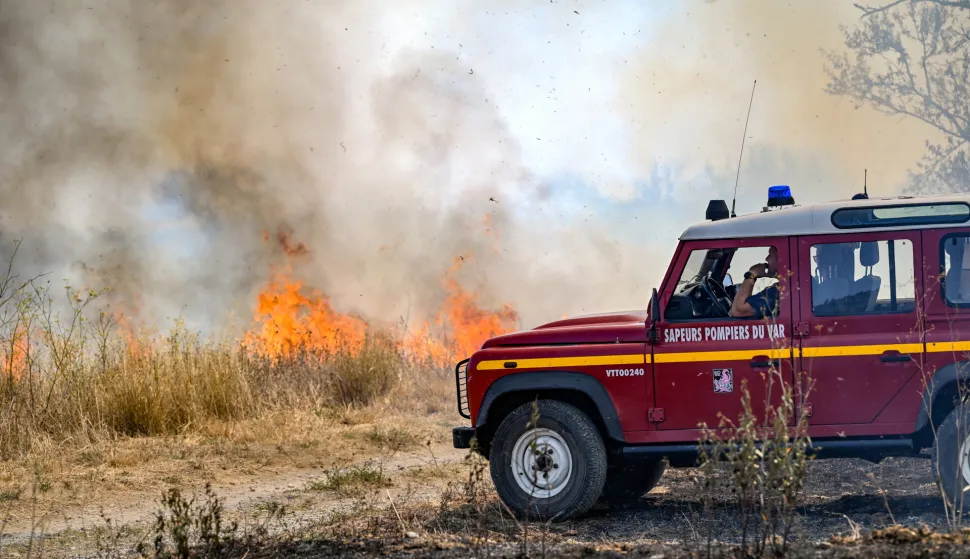 epa12288126 A firefighting crew is deployed to tackle a brush fire as a wildfire continues to spread in Saint-Laurent-de-la-Cabrerisse, Aude department, southern France, 07 August 2025. Some 16,000 hectares have been burned so far and at least one person died in one of the biggest wildfires in France since 1949. EPA/PHILIPPE MAGONI