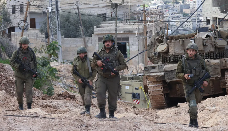 epa11921365 Israeli soldiers in action during a military operation inside the Jenin refugee camp, West Bank, 24 February 2025. The Israeli military launched a military operation in Jenin and its camp on 21 January, resulting in at least 27 Palestinian deaths and dozens of injuries, according to the Palestinian Ministry of Health. EPA/ALAA BADARNEH