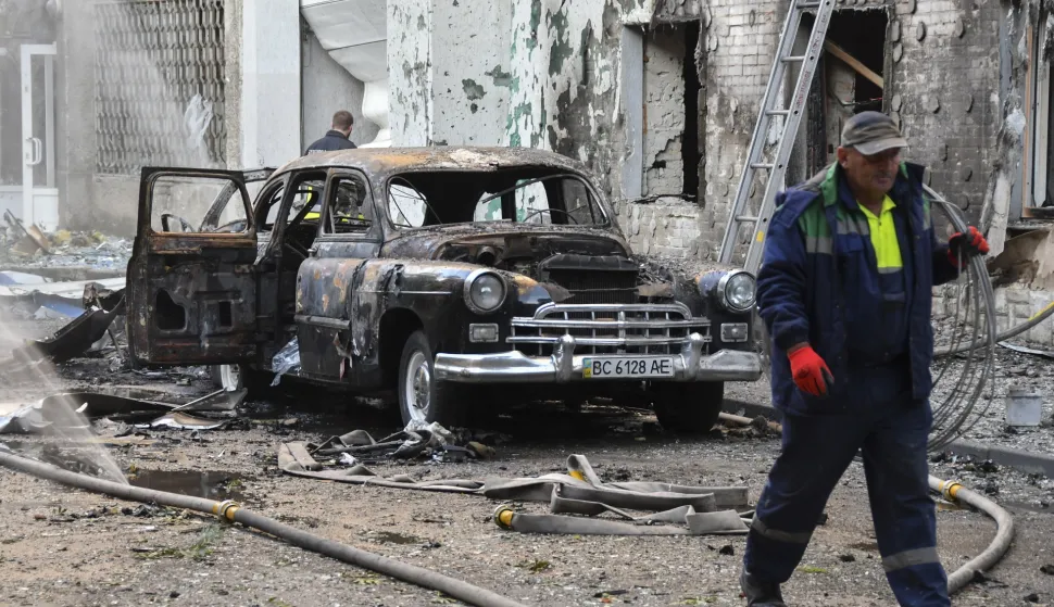 epa12233444 A burned car at the site of a drone strike on a residential building in Lviv, Ukraine, 12 July 2025, amid the Russian invasion. At least two people died and another 14 were injured after a massive overnight combined Russian attack by missiles and shock drones across Ukraine. EPA/MYKOLA TYS