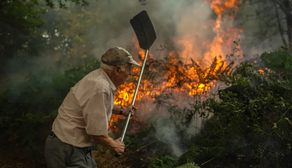 epa12298502 A man battles the flames during a forest fire in the municiplaity of A Pobra de Trives, Ourense province, Spain, 13 August 2025. Multiple blazes continue to affect several provinces in Spain, after burning thousands of hectares across the country. EPA/BRAIS LORENZO