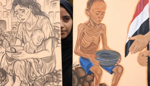 epa12312719 A protester holds anti-Gaza starvation paintings during a rally in solidarity with the Palestinian people, in Sana'a, Yemen, 20 August 2025. Hundreds of people rallied at Sana'a University to demand an end to the war in the Gaza Strip and the entry of all humanitarian aid into the enclave. EPA/YAHYA ARHAB