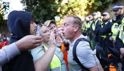 epa12316970 A protestor is confronted as anti-racist protestors march towards the TLK Apartments Hotel housing asylum seekers during a demonstration against the far-right in Orpington, Britain, 22 August 2025. Far-right protests outside hotels housing migrants have been increasing across the UK in recent weeks, with counter-protests also taking place. EPA/TOLGA AKMEN