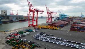 epa11880928 An aerial photograph taken with a drone of cars and JCBs lined up in front of stacked containers at Seaforth Dock container terminal in Liverpool, Britain, 07 February 2025. US President Donald Trump has imposed 10 percent tariffs on China, with planned tariffs on Mexico and Canada being delayed after last minute talks. The US President has said that tariffs may also be imposed on the EU and the UK, which exports goods and services including energy, cars, machinery and pharmaceuticals to the US. EPA/ADAM VAUGHAN