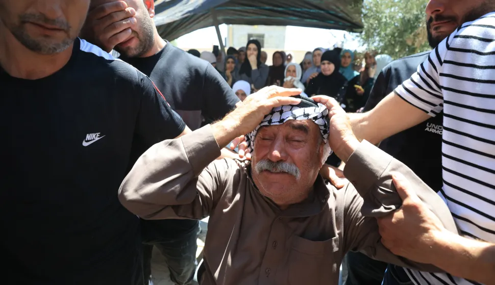 epa12306170 People mourn during the funeral for a Palestinian youth at Al-Mughayyir village near the West Bank city of Ramallah, 17 August 2025. According to the Palestinian news agency Wafa, an 18-year-old Palestinian youth succumbed to his wounds after being shot by Israeli forces during a military raid in the village on 16 August. EPA/ALAA BADARNEH