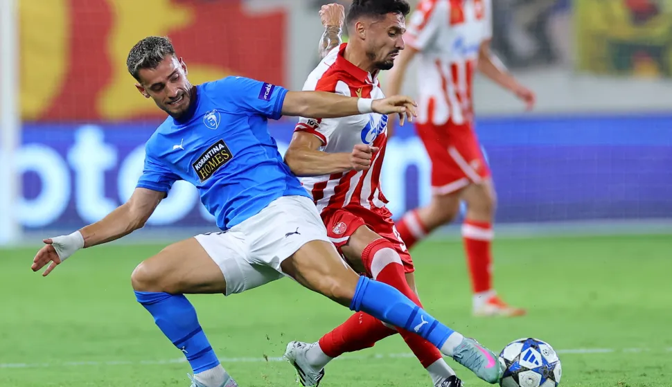 epa12324801 Vlad Dragomir (L) of Pafos in action against Rade Krunic of Crvena Zvezda during the UEFA Champions League play-offs, 2nd leg match between Pafos and Crvena Zvezda in Limassol, Cyprus, 26 August 2025. EPA/SAKIS SAVVIDES