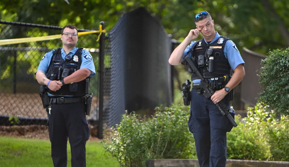 epa12327021 A police officer wipes his eye as he and other officers respond to a shooting at the Annunciation Catholic School in Minneapolis, Minnesota, USA, 27 August 2025. According to police, three people including the gunman died in the shooting at a Catholic primary church and 20 were injured. EPA/CRAIG LASSIG